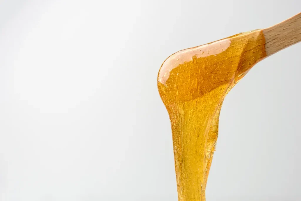 Close-up of natural sugar wax used for body sugaring services in Waterdown at Lacey's